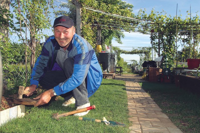 Nedeljko med urejanjem ograjice iz starih kopalniških ploščic