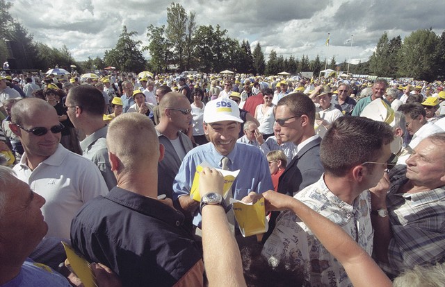 Darko Njavro (levo s sončnimi očali) kot vodja osebnega varovanja Janeza Janše na festivalu stranke SDS v Ribnici leta 2000 Darko Njavro (levo s sončnimi očali) kot vodja osebnega varovanja Janeza Janše na festivalu stranke SDS v Ribnici leta 2000